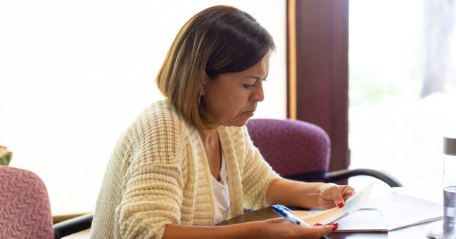 Teacher evaluating materials