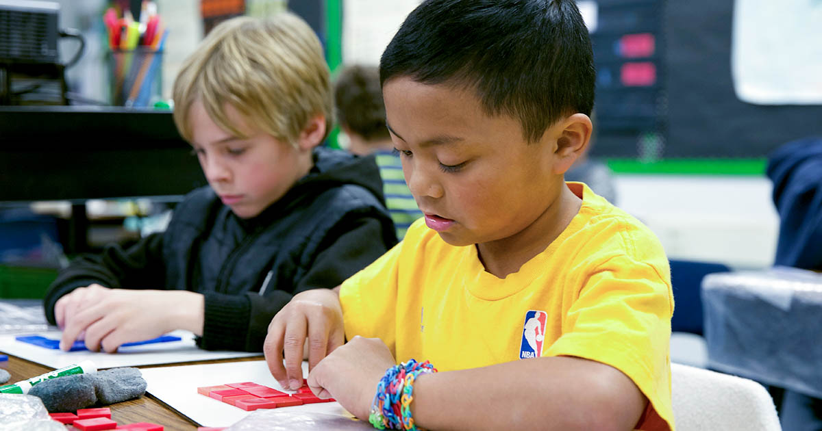 Two young students in a classroom