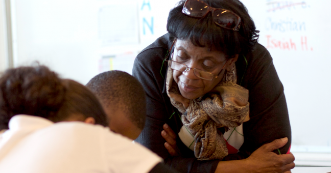 Teacher with student in the classroom