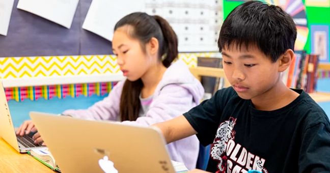 Photo of kids on computers in classroom