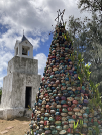 A Christmas tree in the Malesso Village on southern Guam that stands nearly 20 feet and is made of coconuts painted by individuals and families from all across the island. Credit: Jon Boxerman, June 2022.