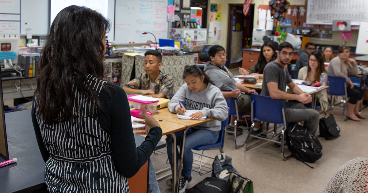 Science students receiving instruction from their teacher